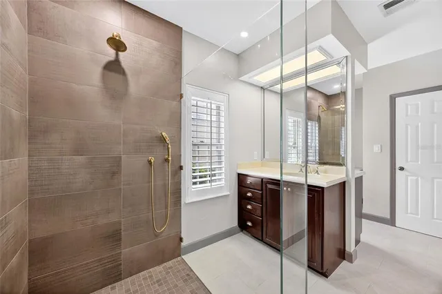 a bathroom with double vanity and a shower