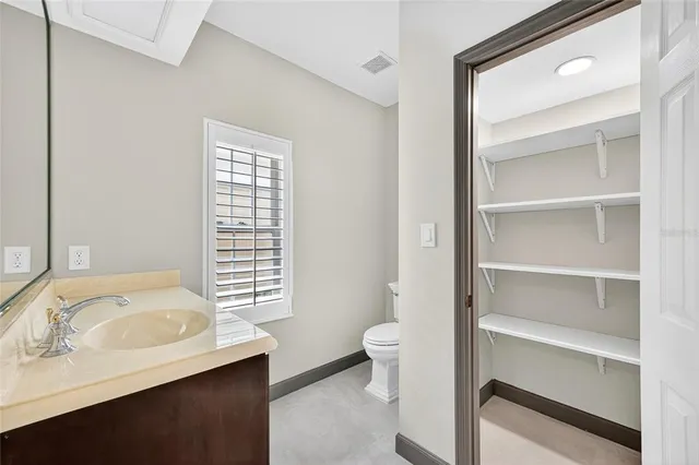 a bathroom with a granite countertop sink a toilet and bathtub