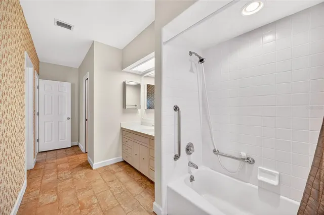 a bathroom with a bathtub and a shower