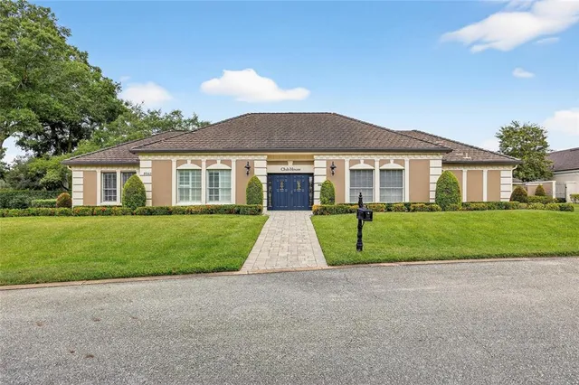 a living room with furniture and large windows