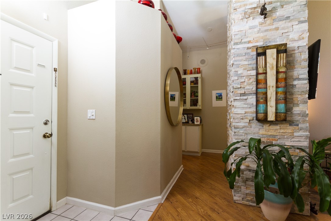 133 Coventry Circle Henderson, NV 89074 - Photo 4 of 99 Front door entry. Hall to bedrooms. Fireplace & living room to right.