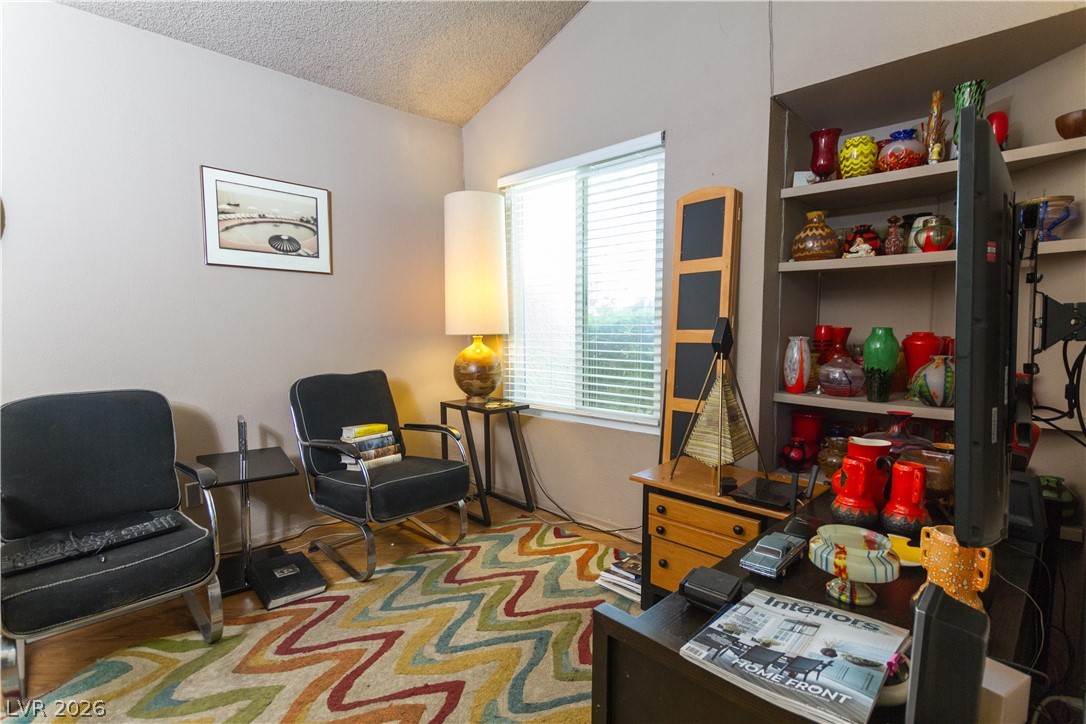 133 Coventry Circle Henderson, NV 89074 - Photo 59 of 99 Den with built-in shelves. Window to front of house.