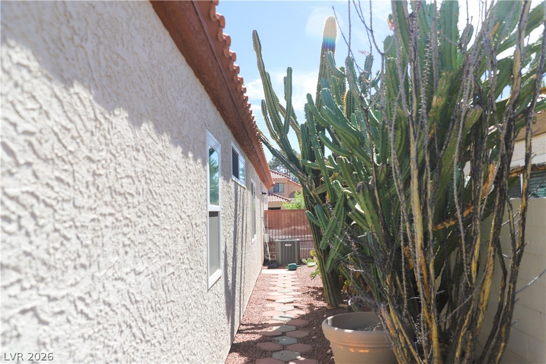 133 Coventry Circle Henderson, NV 89074 - Photo 86 of 99 Side of structure to AC unit & exterior garage entry