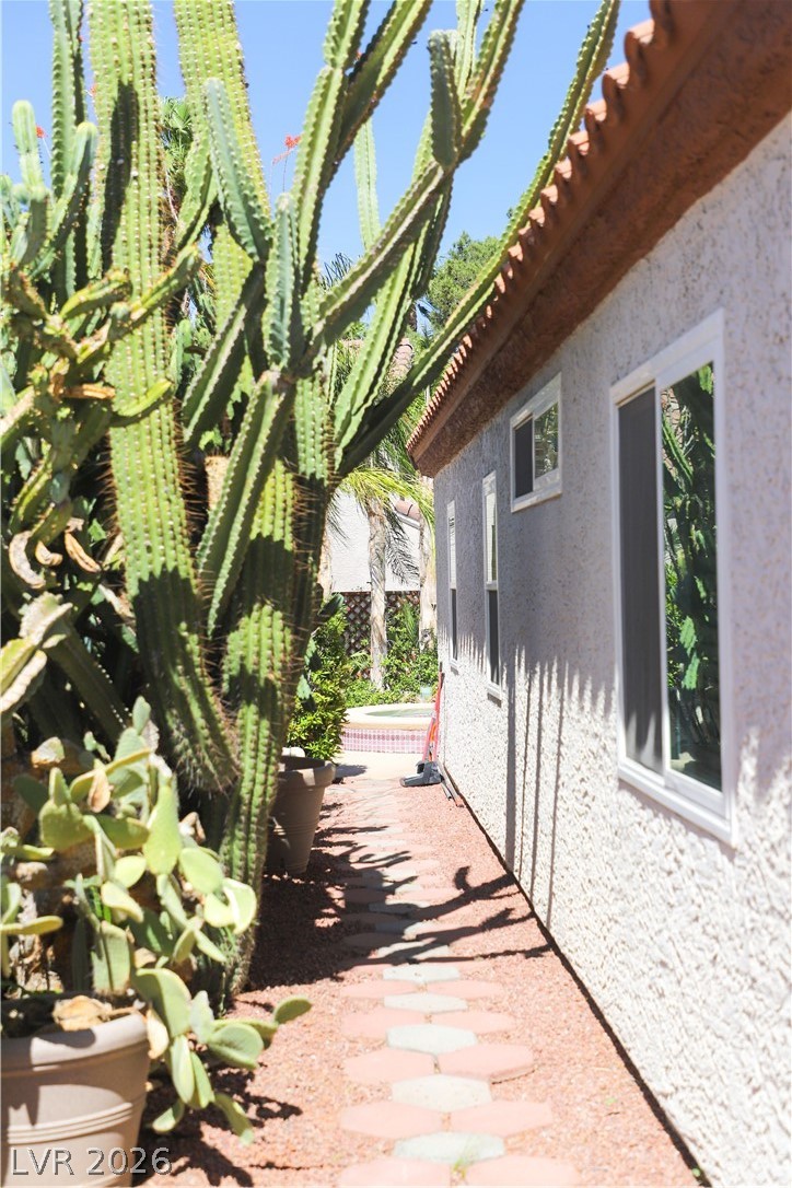 133 Coventry Circle Henderson, NV 89074 - Photo 89 of 99 Side of structure. Path from garage exterior door to backyard.