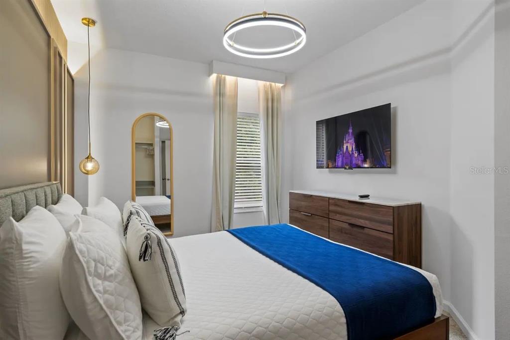 10317 Ebb Tide Lane Orlando, FL 32821 - Photo 15 of 47 a bedroom with a bed and a dresser