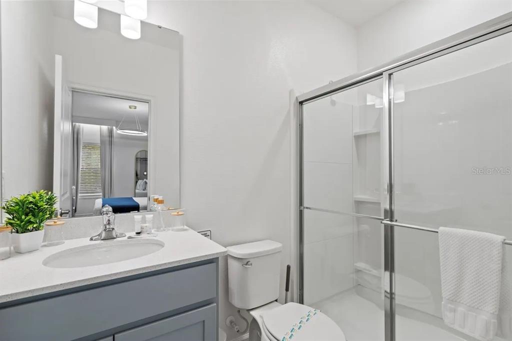 10317 Ebb Tide Lane Orlando, FL 32821 - Photo 16 of 47 a bathroom with a sink toilet and shower