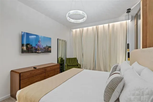 a view of a bedroom with a bed and a window