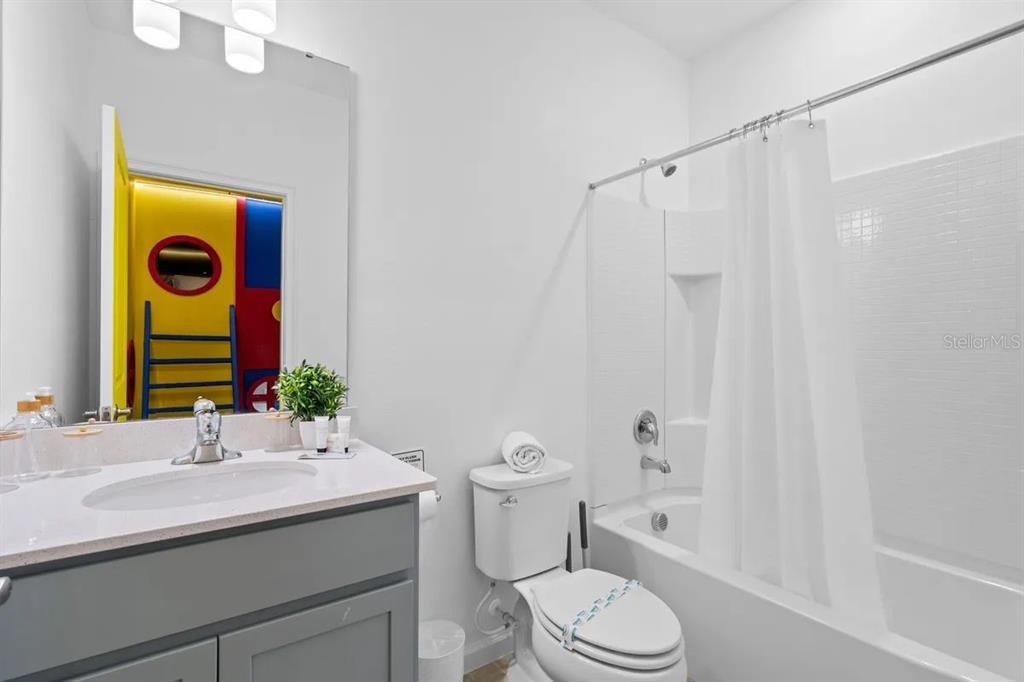 10317 Ebb Tide Lane Orlando, FL 32821 - Photo 34 of 47 a bathroom with a sink a toilet and shower