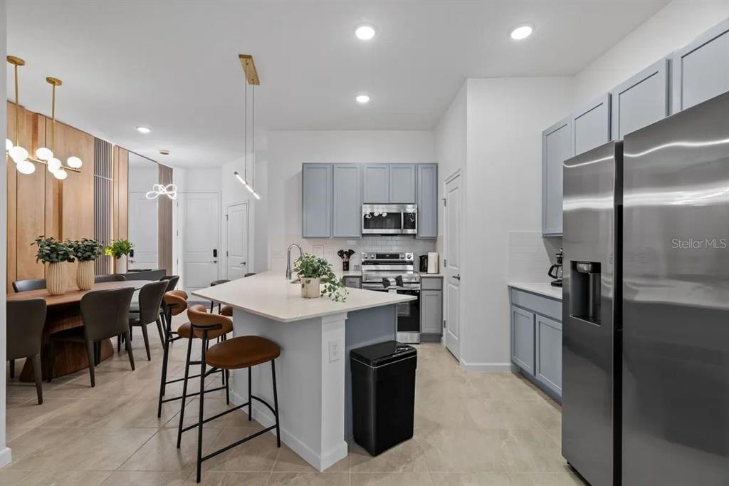 10317 Ebb Tide Lane Orlando, FL 32821 - Photo 5 of 47 a kitchen with sink cabinets and stainless steel appliances