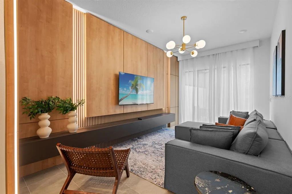 10317 Ebb Tide Lane Orlando, FL 32821 - Photo 6 of 47 a living room with furniture and a chandelier