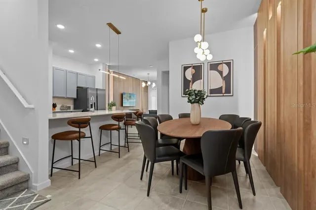 a view of a dining room with furniture and chandelier