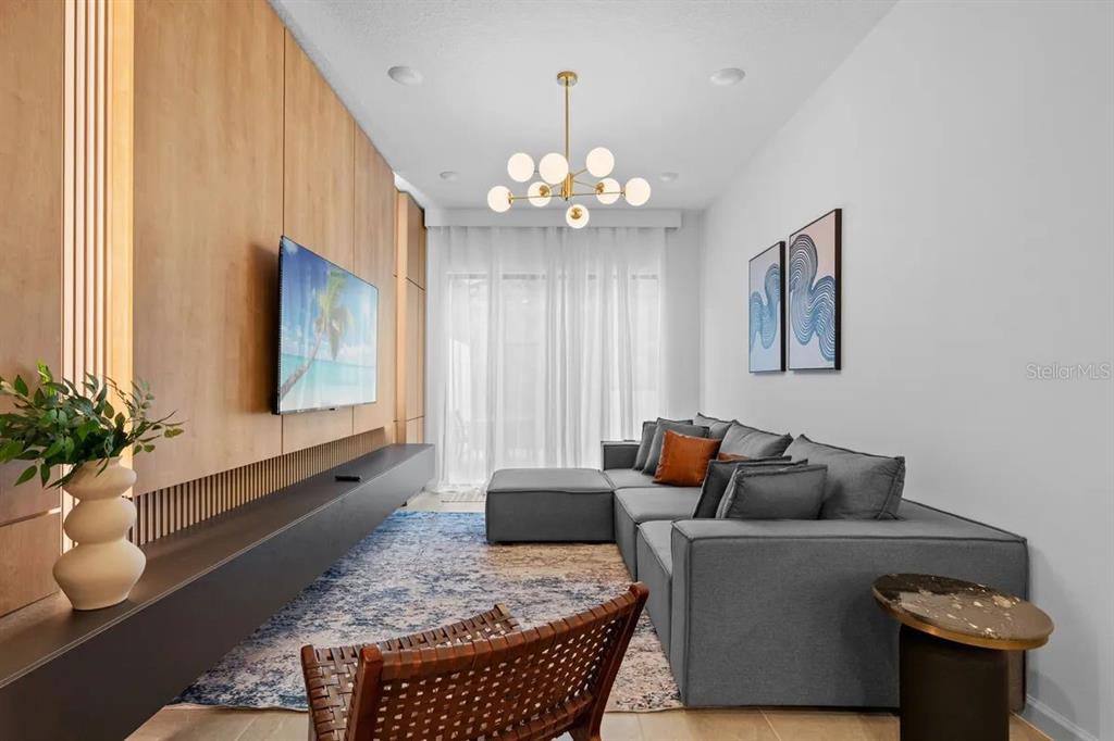 10317 Ebb Tide Lane Orlando, FL 32821 - Photo 9 of 47 a living room with furniture and a chandelier