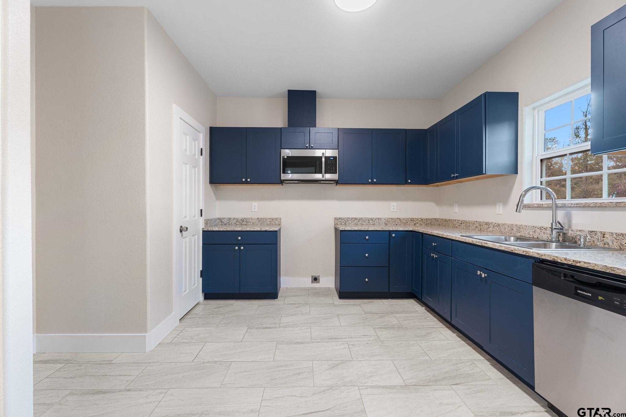 2924 Old Noonday Road Tyler, TX 75701 - Photo 8 of 25 a kitchen with stainless steel appliances granite countertop a sink and cabinets