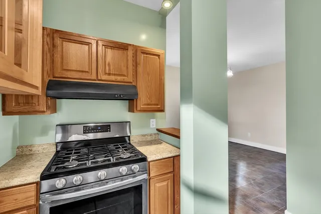 a stove top oven sitting inside of a kitchen