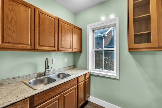 a kitchen with a sink cabinets and window