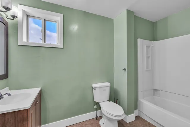 a white toilet sitting next to a bathroom sink