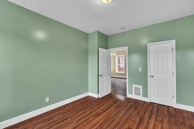 a view of a room with wooden floor and windows
