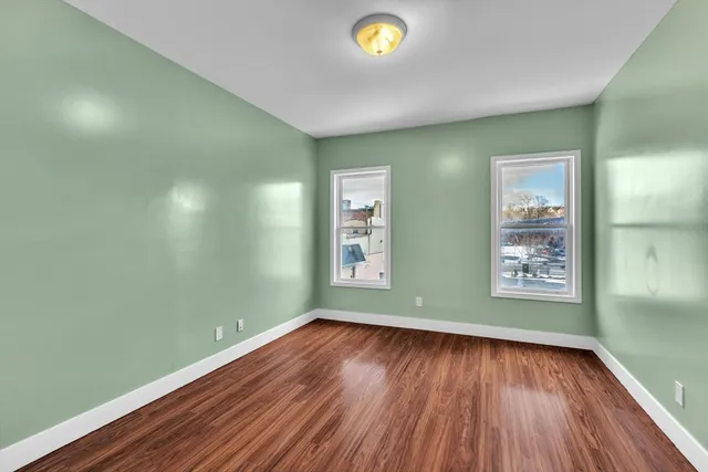 a view of room with window and wooden floor