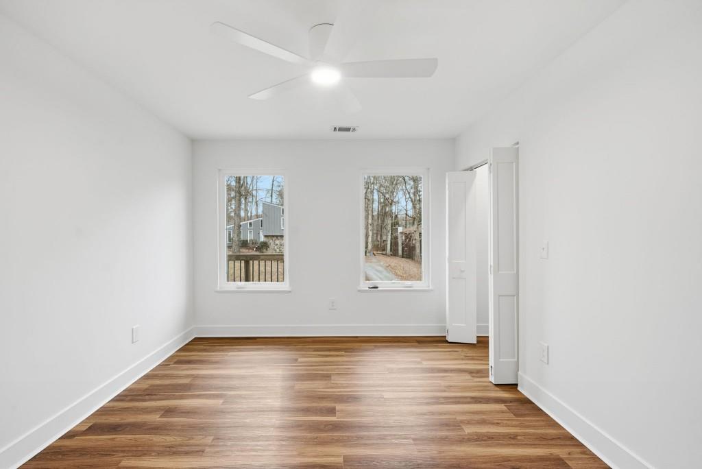 3668 Big Springs Road Decatur, GA 30034 - Photo 22 of 45 an empty room with wooden floor and windows