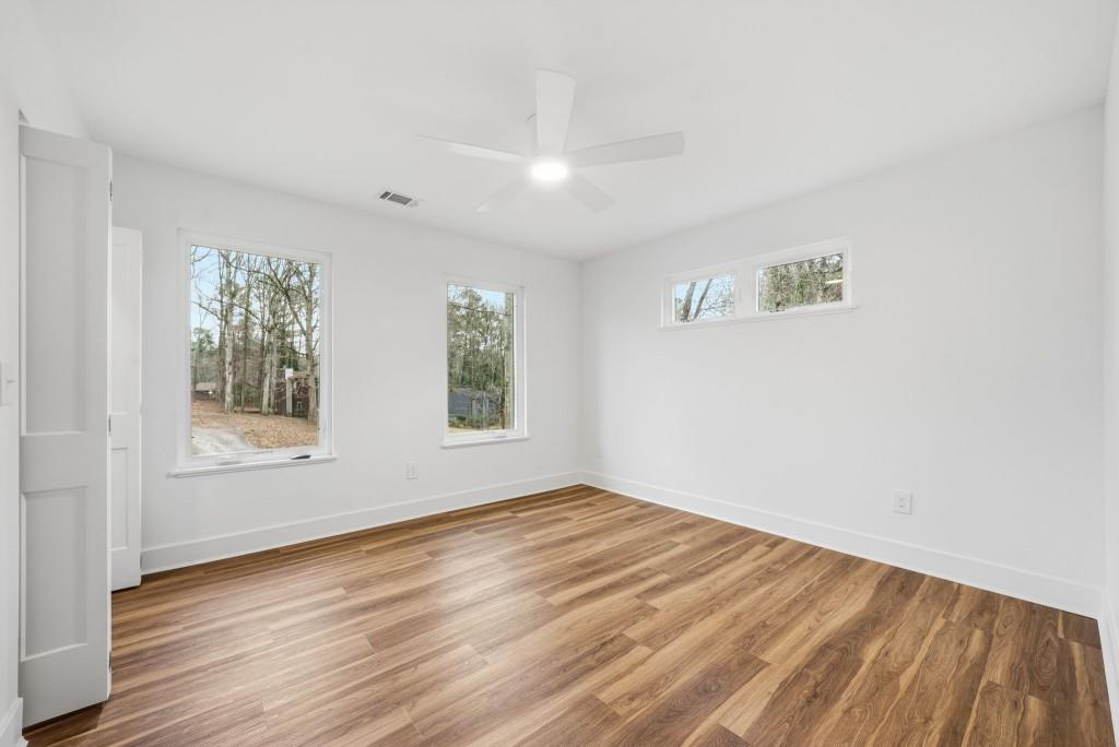 3668 Big Springs Road Decatur, GA 30034 - Photo 25 of 45 an empty room with wooden floor and windows