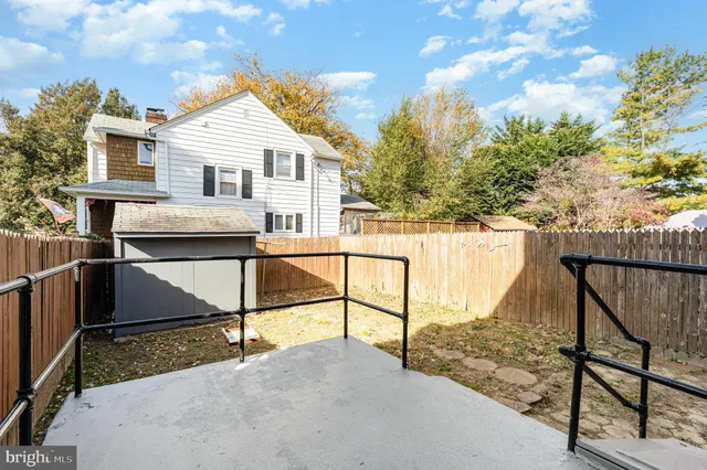 a view of a house with wooden fence