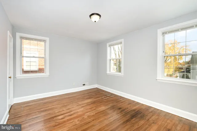 a view of a room with wooden floor and windows