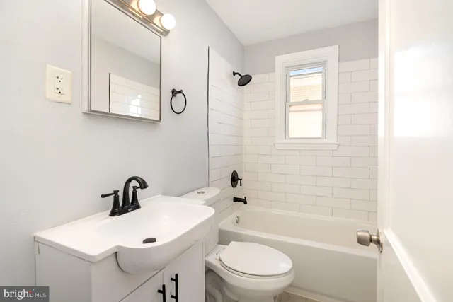 a white toilet sitting next to a bathroom sink