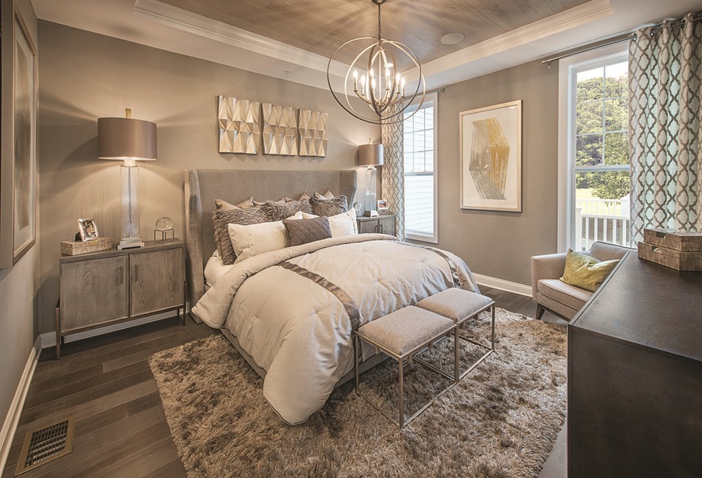 11 Hummingbird Way, Unit 148 Methuen, MA 01844 - Photo 4 of 16 a spacious bedroom with a bed and a chandelier