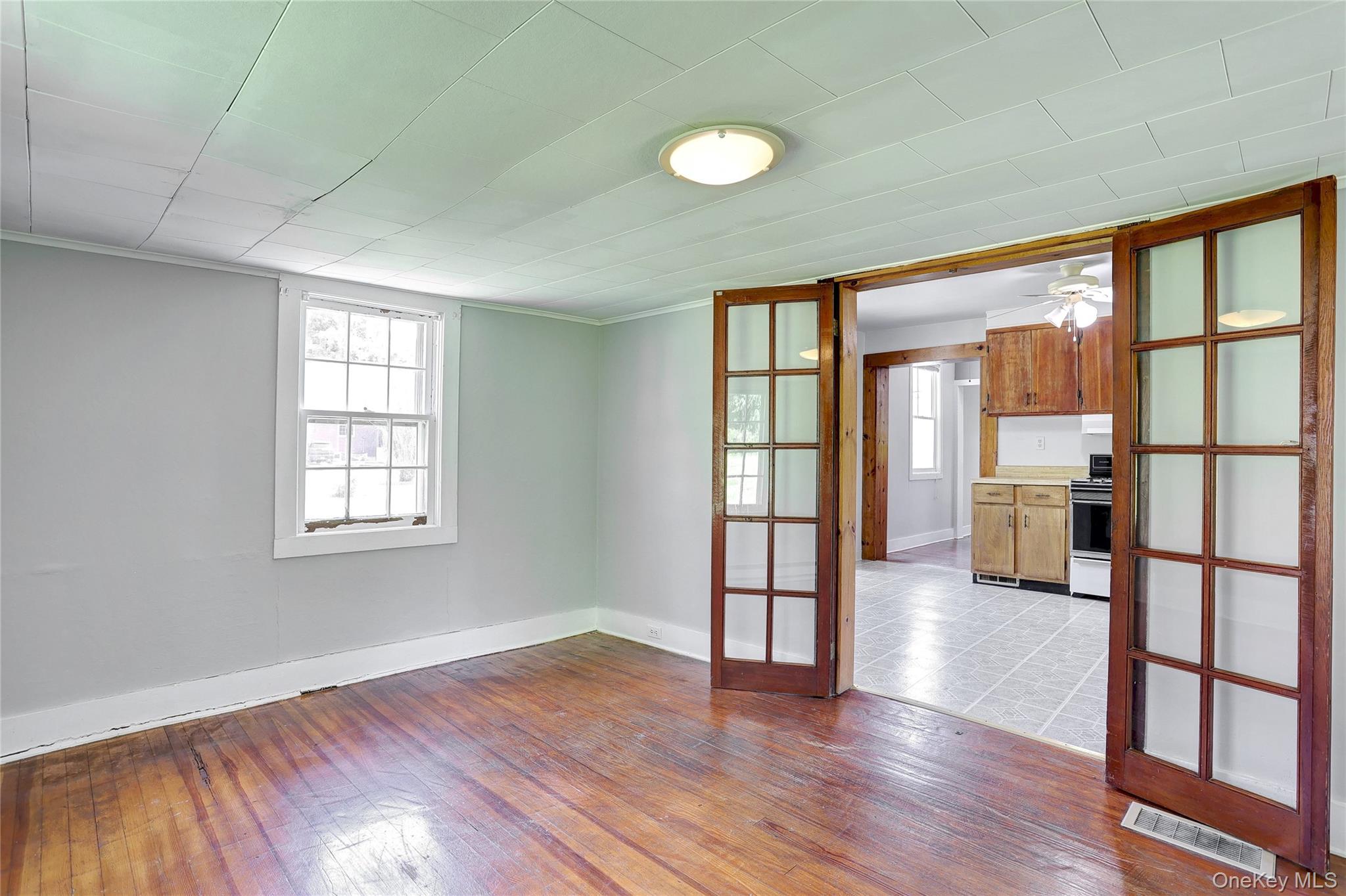 500 Haverstraw Road Suffern, NY 10901 - Photo 11 of 36 an empty room with wooden floor and windows