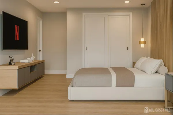 a living room with a bed furniture and a flat screen tv