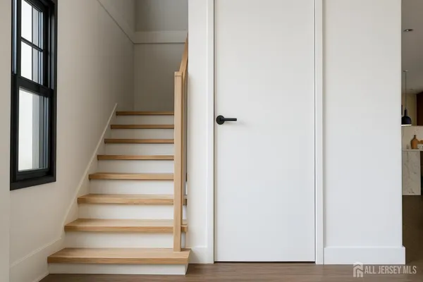 a view of staircase with white walls and windows