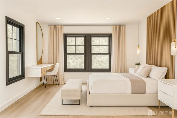 a bedroom with a large bed and a large window