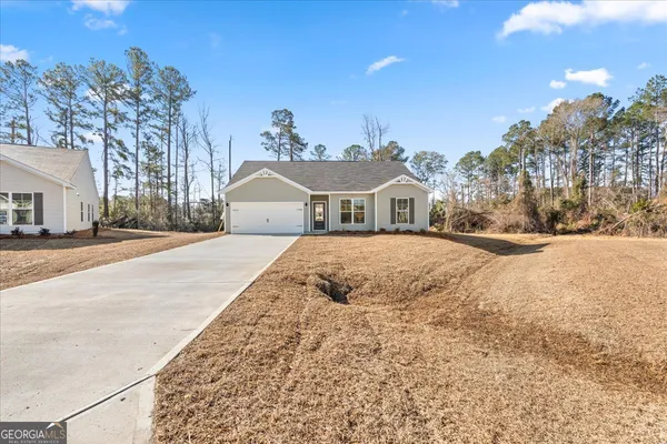 a view of the house with a yard