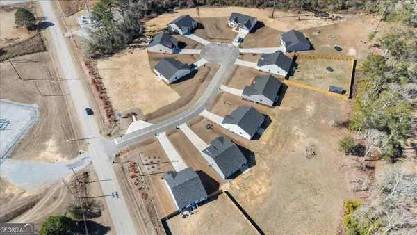 an aerial view of a house with a swimming pool