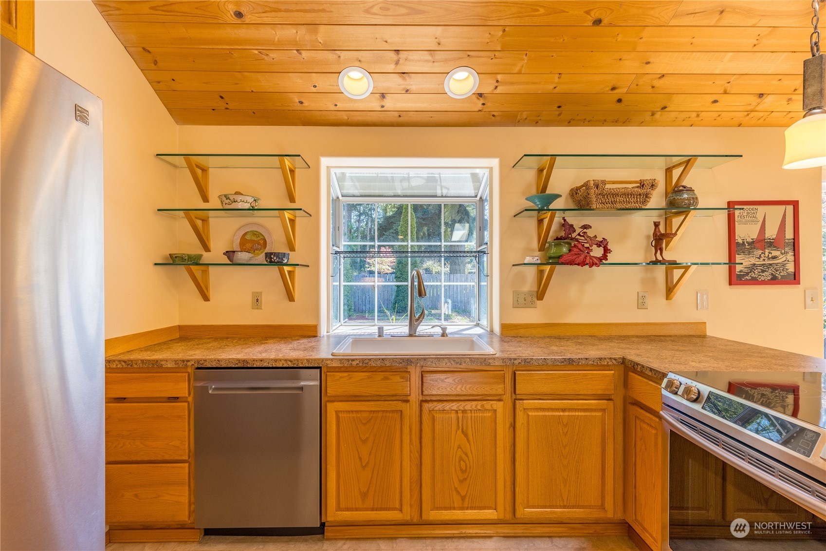 131 Riverside Road Sequim, WA 98382 - Photo 14 of 40 a view of a kitchen with a sink and dishwasher next to a window
