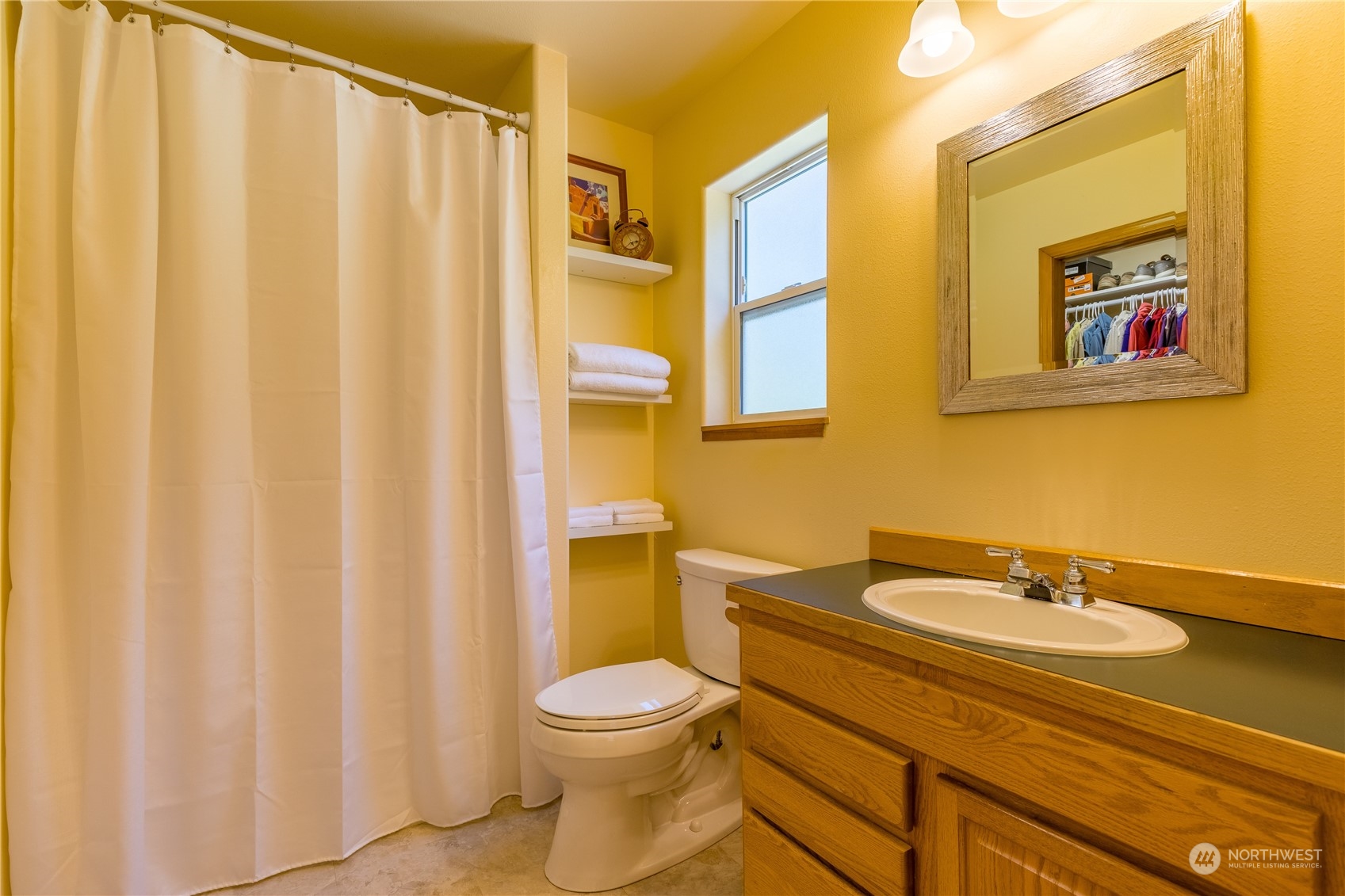 131 Riverside Road Sequim, WA 98382 - Photo 24 of 40 a bathroom with a sink and a mirror