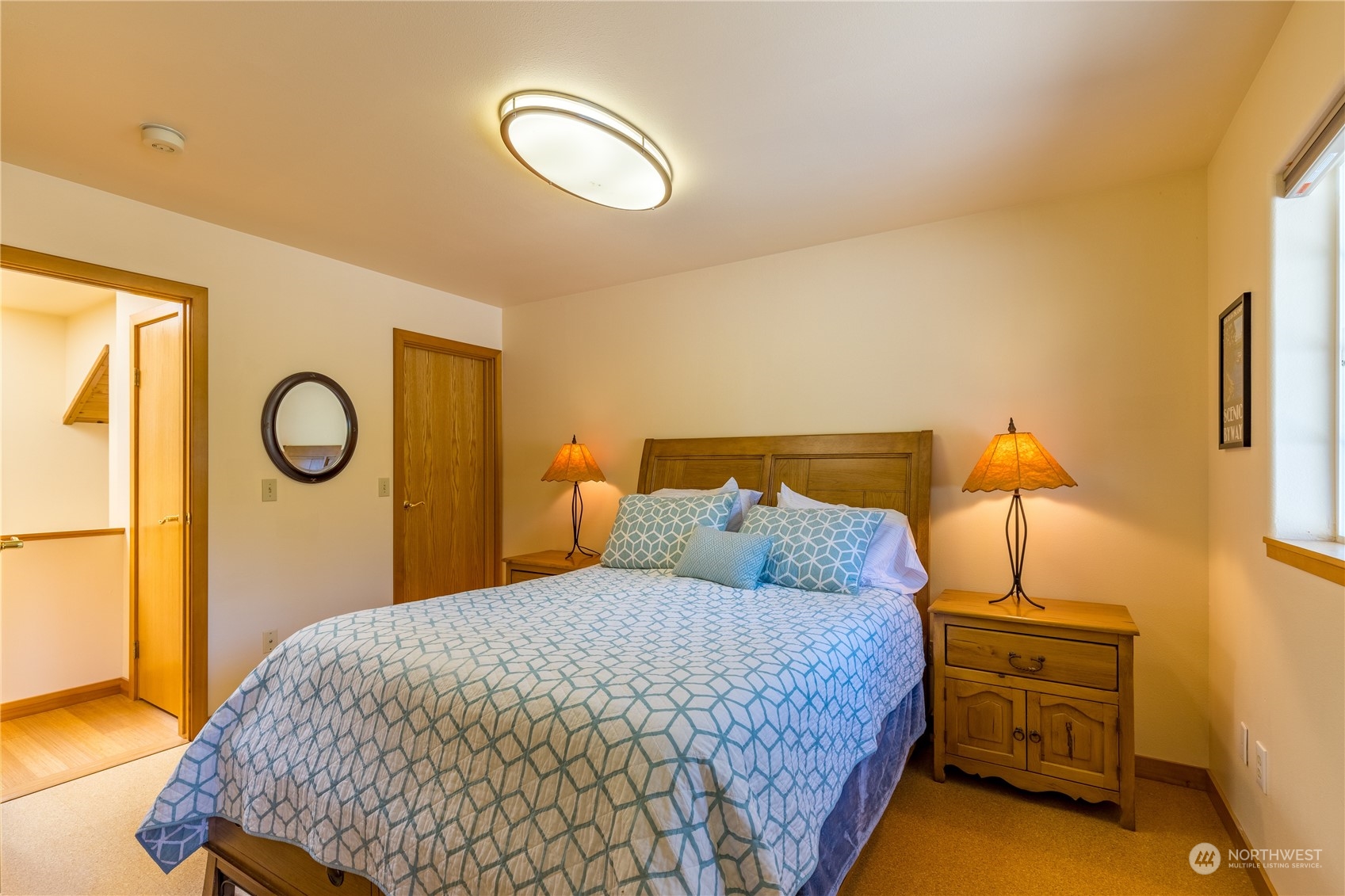 131 Riverside Road Sequim, WA 98382 - Photo 26 of 40 a bedroom with a bed and dresser with mirror