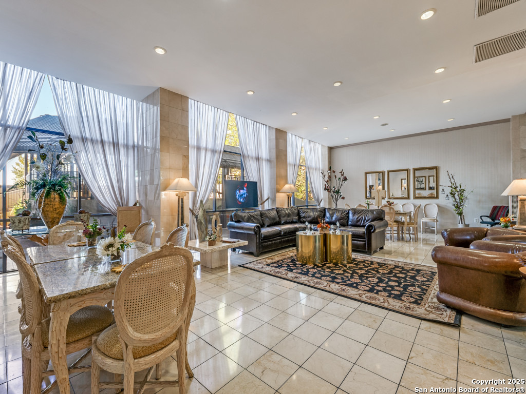 7701 Wurzbach Road, Unit 806 San Antonio, TX 78229 - Photo 11 of 20 a living room with lots of furniture and a floor to ceiling window
