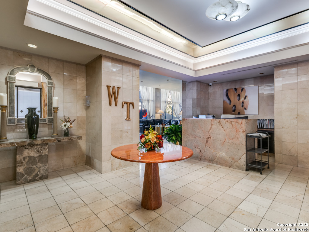 7701 Wurzbach Road, Unit 806 San Antonio, TX 78229 - Photo 12 of 20 a living room with furniture and a table