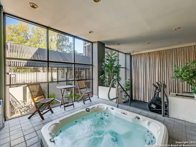 a living room with furniture and a floor to ceiling window