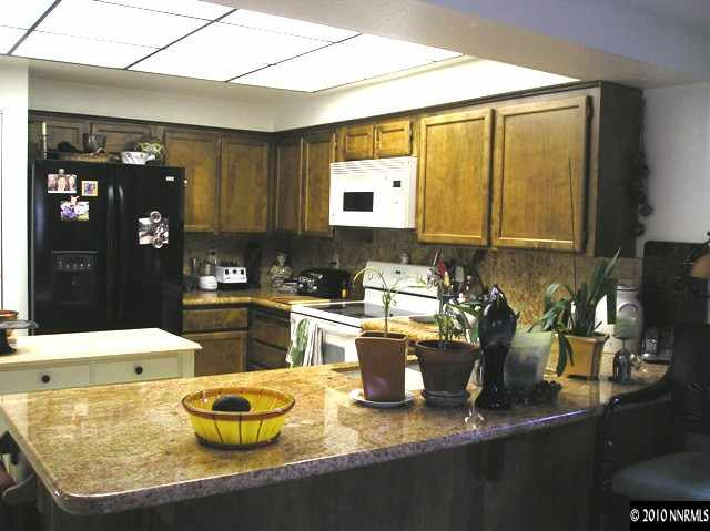 326 West Riverview Circle Reno, NV 89509 - Photo 2 of 9 a kitchen with sink a stove and chairs