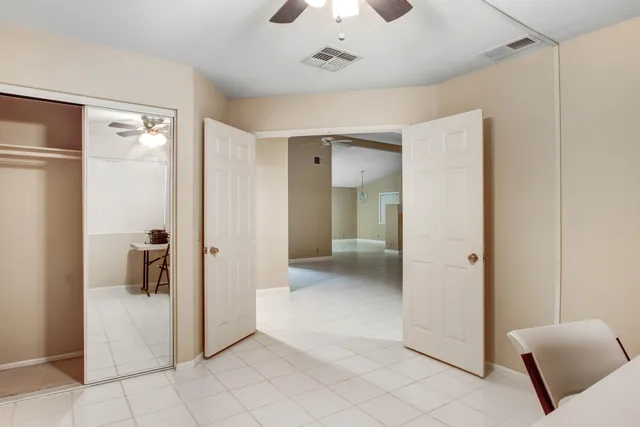 a view of a hallway and a livingroom with furniture