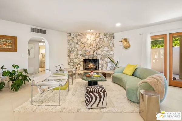 a living room with furniture and a fireplace