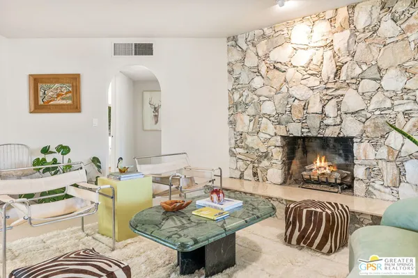 a living room with furniture and a fireplace