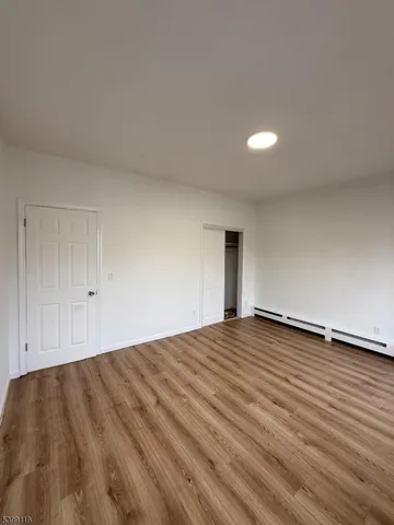 a view of an empty room and wooden floor