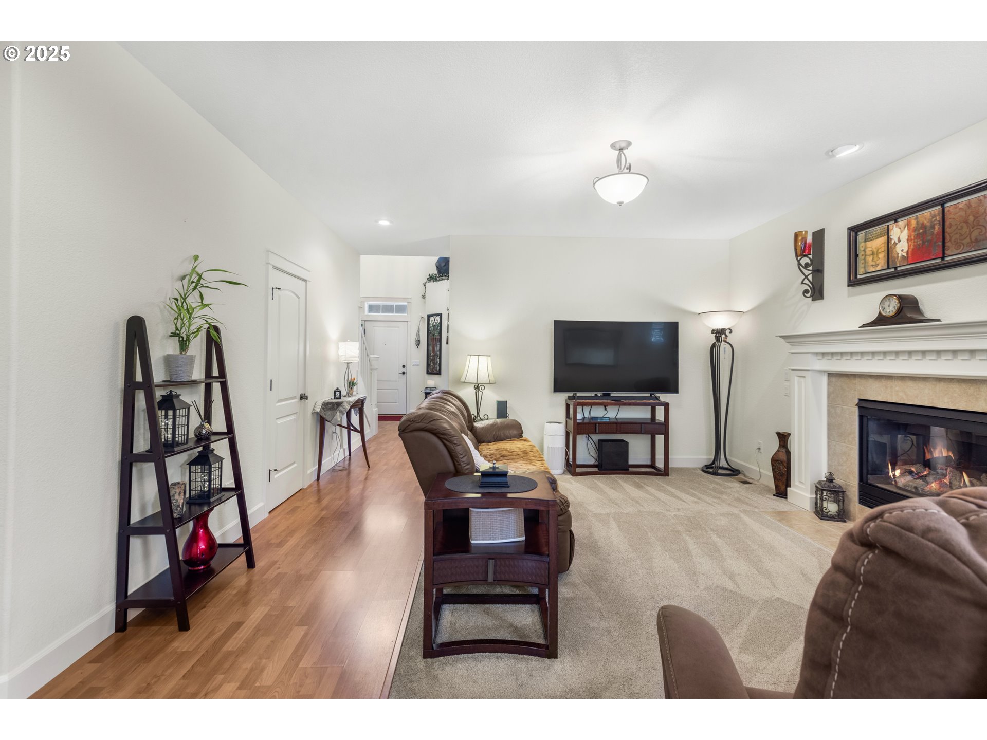 3369 Falcon Drive Springfield, OR 97477 - Photo 11 of 47 a living room with furniture a flat screen tv and a fireplace