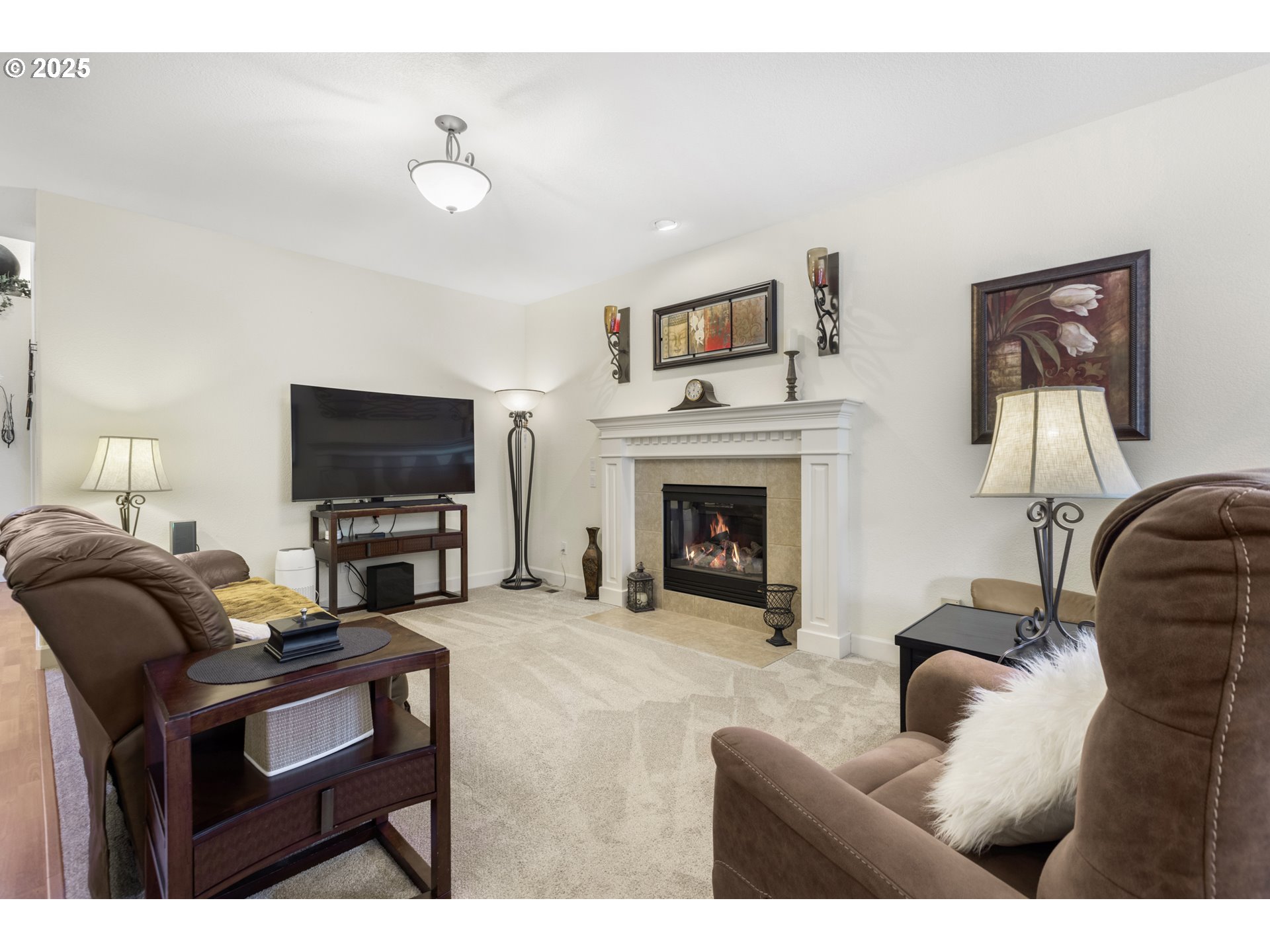 3369 Falcon Drive Springfield, OR 97477 - Photo 12 of 47 a living room with furniture a flat screen tv and a fireplace