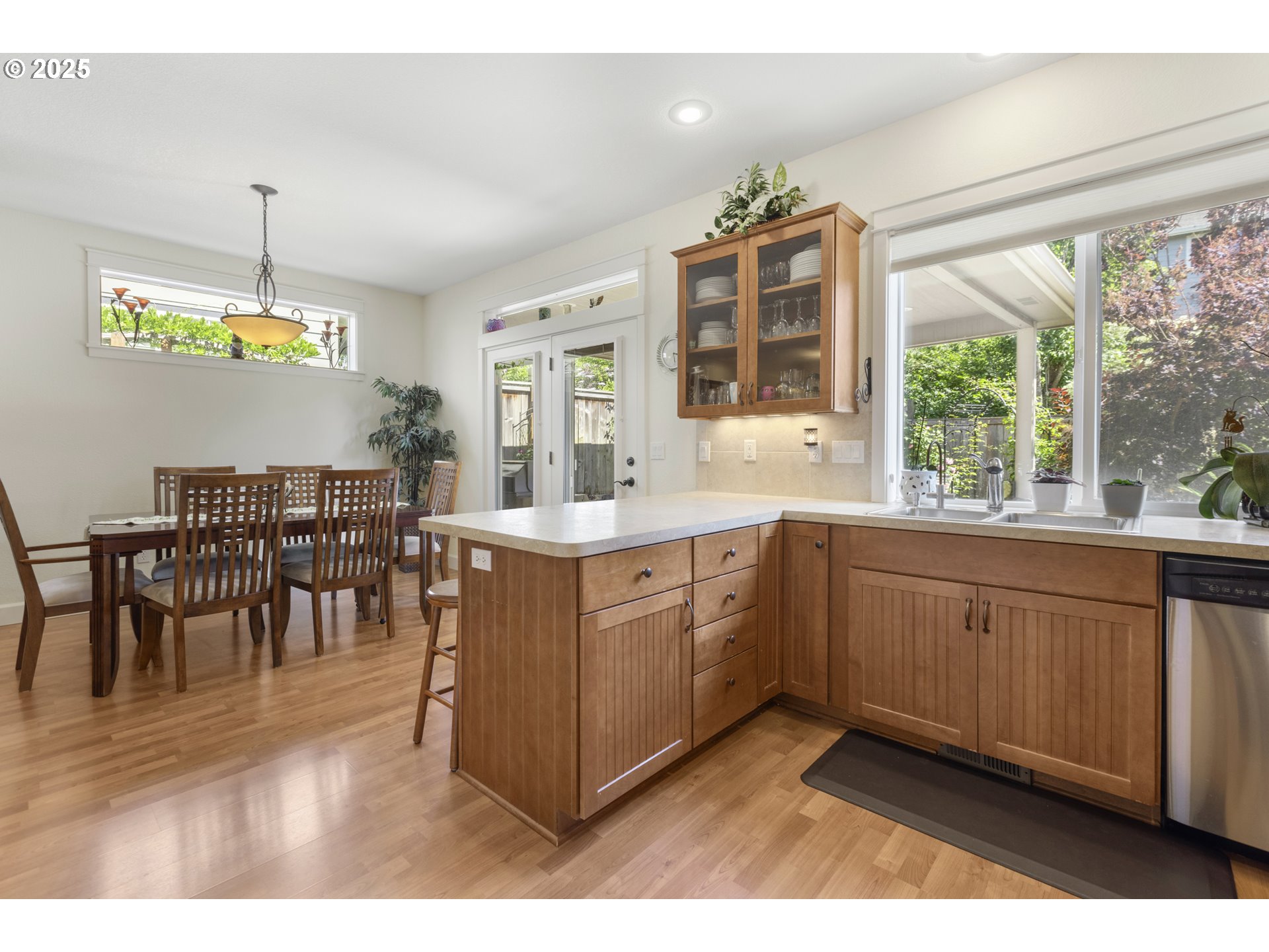3369 Falcon Drive Springfield, OR 97477 - Photo 17 of 47 a open kitchen with granite countertop a stove a sink a dining table and chairs with wooden floor