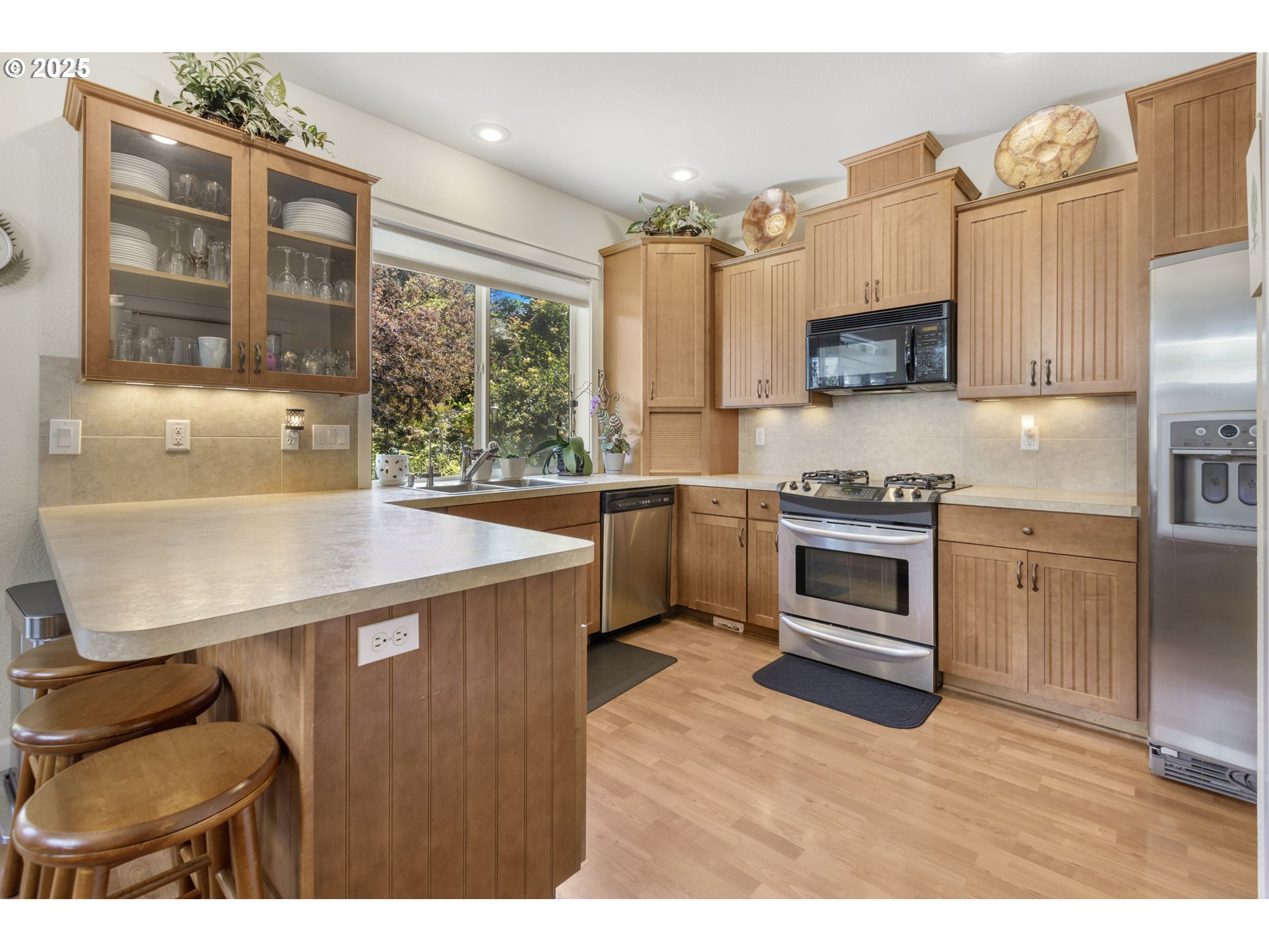 3369 Falcon Drive Springfield, OR 97477 - Photo 19 of 47 a kitchen with stainless steel appliances a stove sink and cabinets