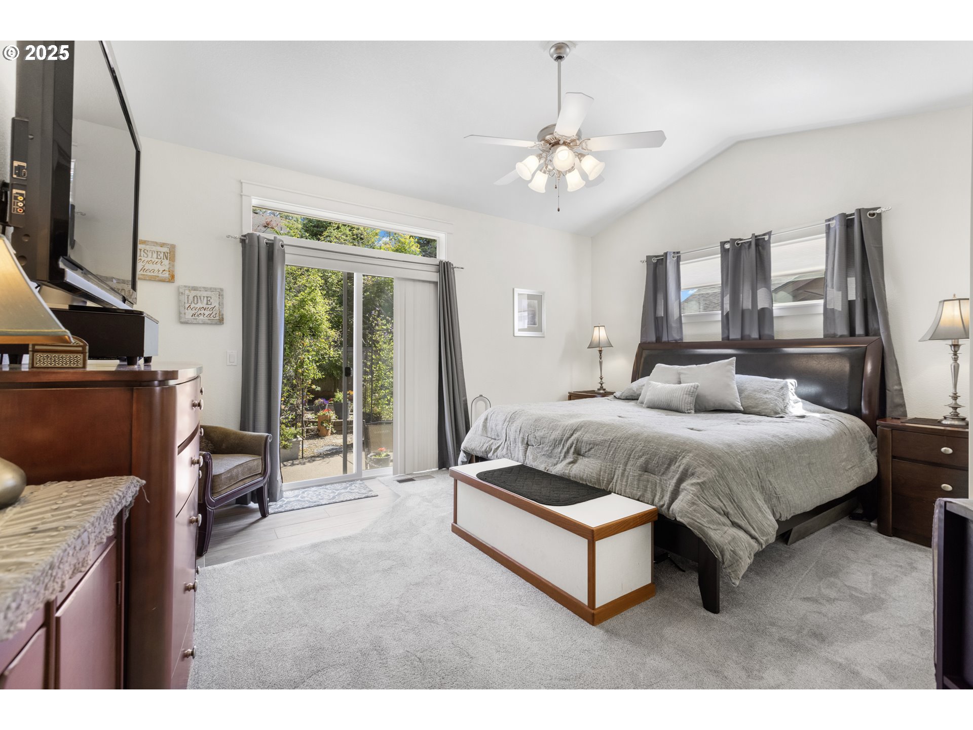 3369 Falcon Drive Springfield, OR 97477 - Photo 22 of 47 a spacious bedroom with a bed a couch and a flat tv screen on dresser